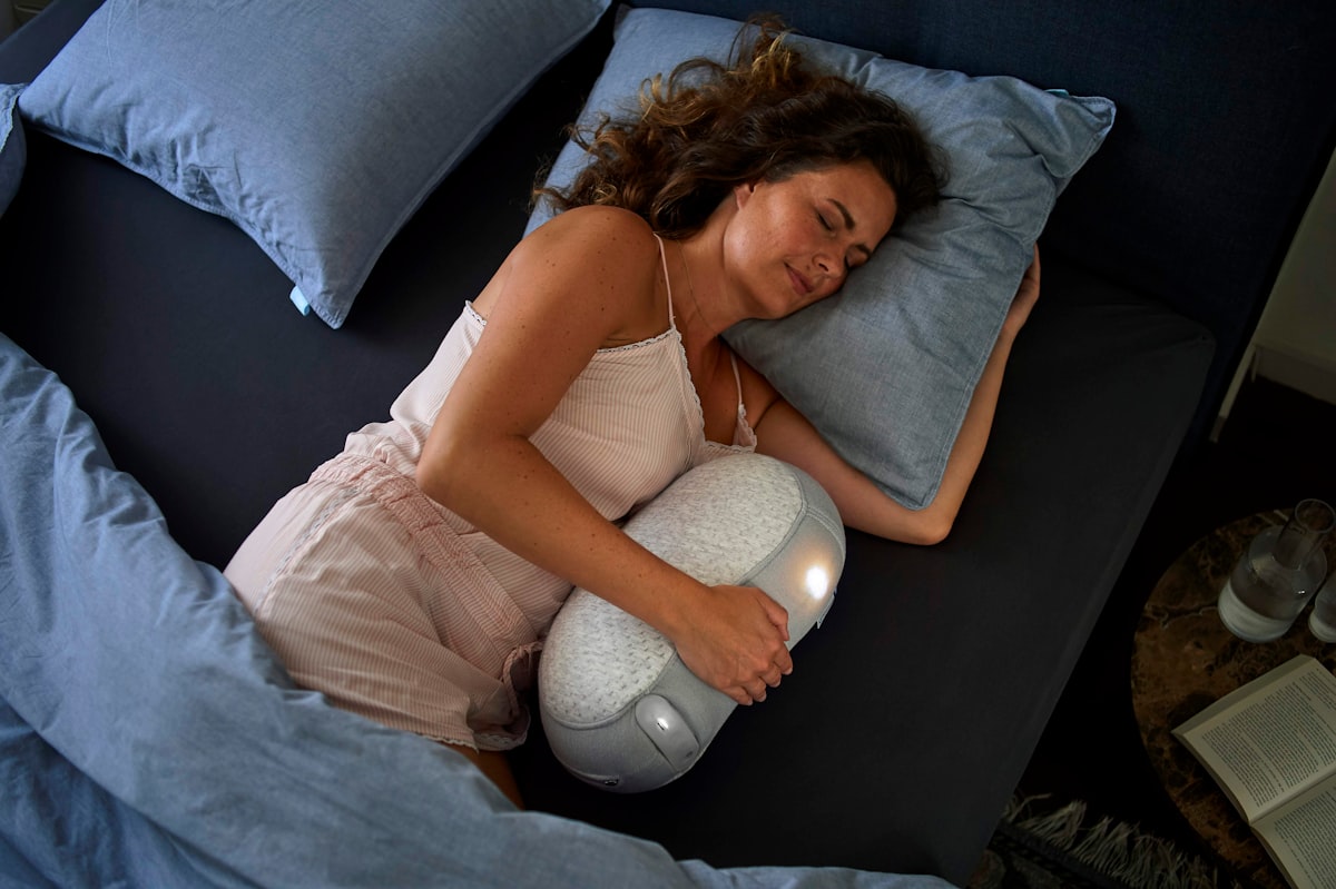Woman sleeping peacefully in comfortable bed